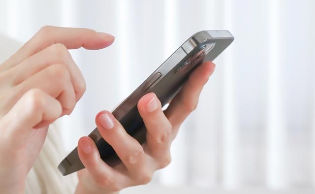 家族葬の足立区葬儀社に電話でお問合せしようとしている人の手元。